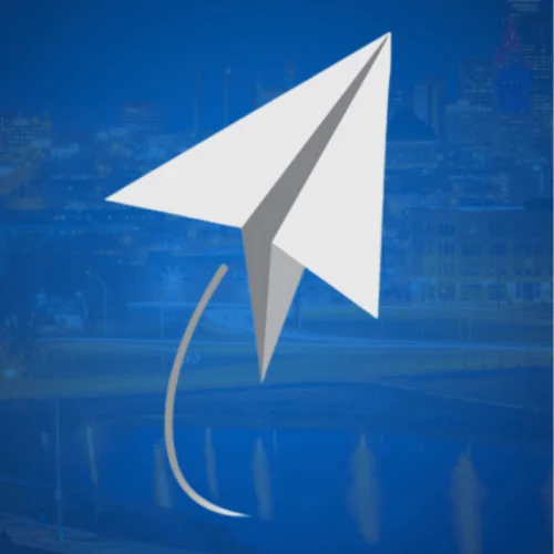 Prevail Innovative Wealth Strategies paper plane logo over the Kansas City Missouri skyline, symbolizing forward-thinking financial strategy and growth.